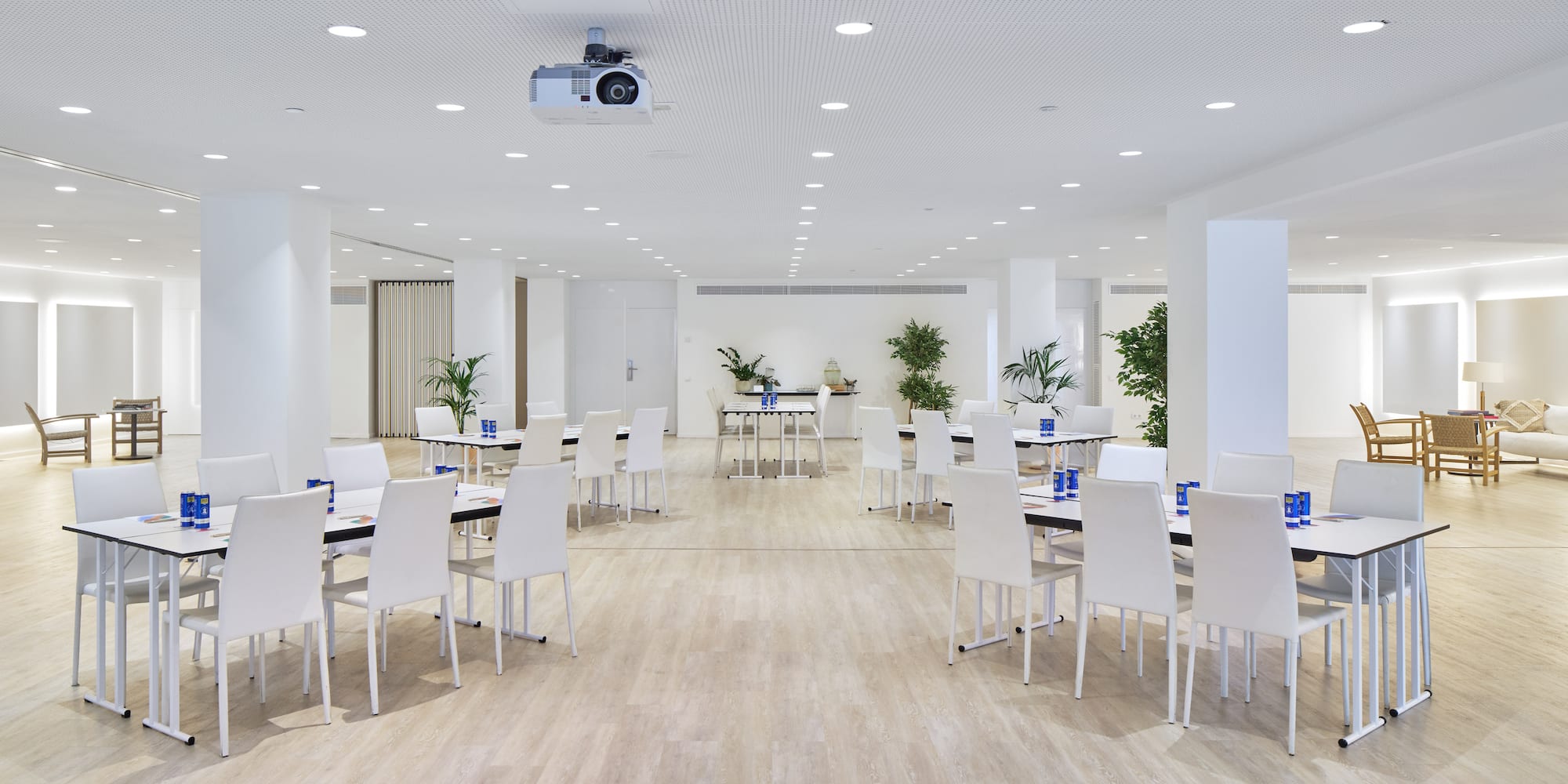 a room with white chairs and tables