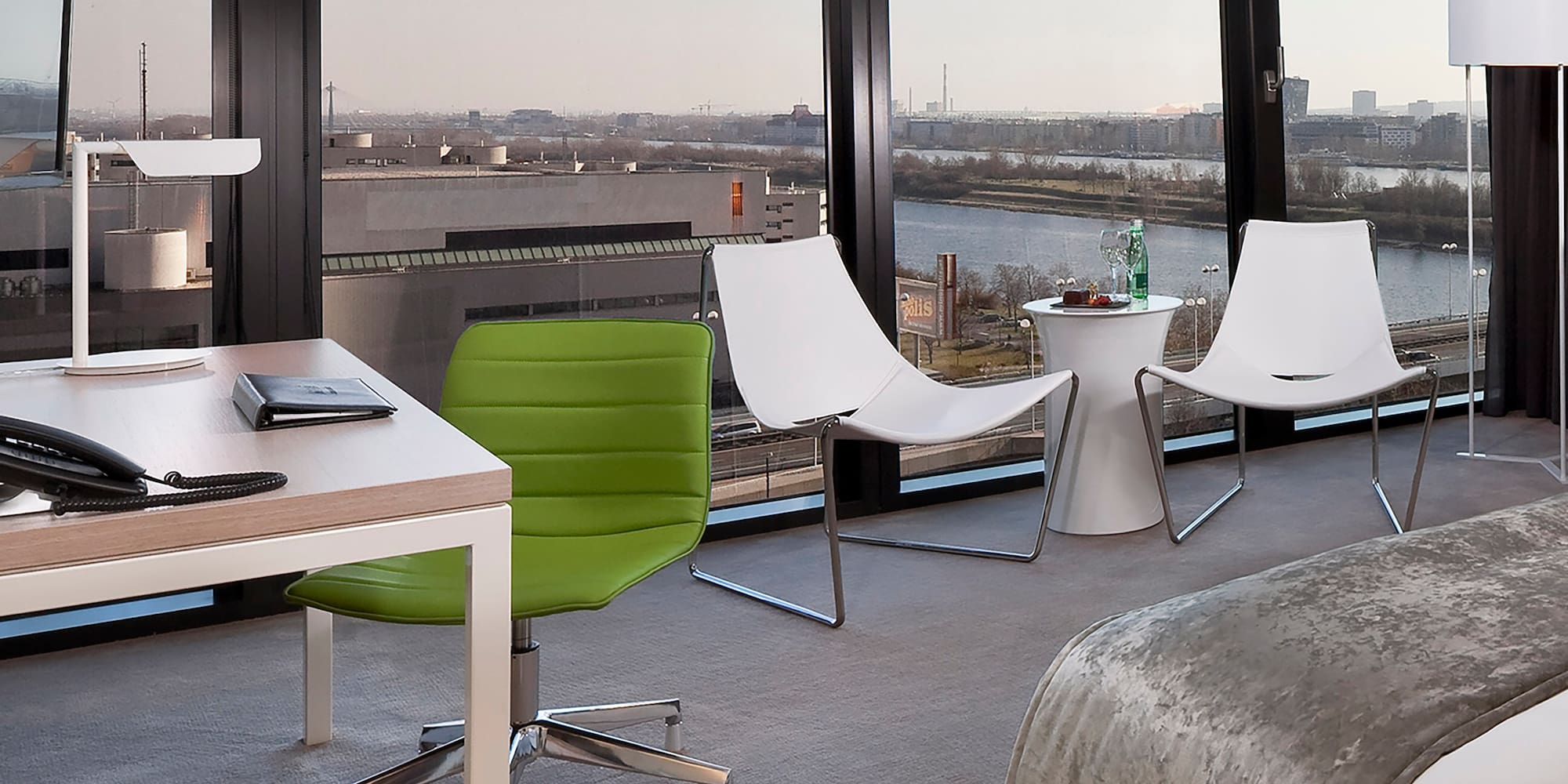 a room with a bed and chairs and a table