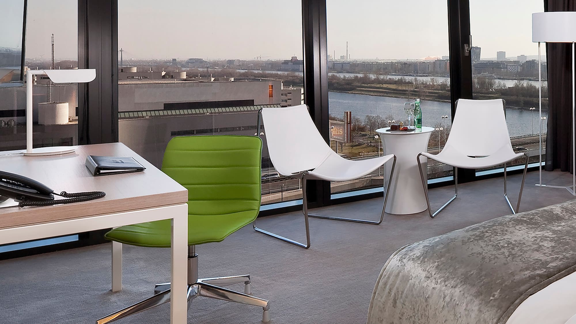 a room with a bed and chairs and a table