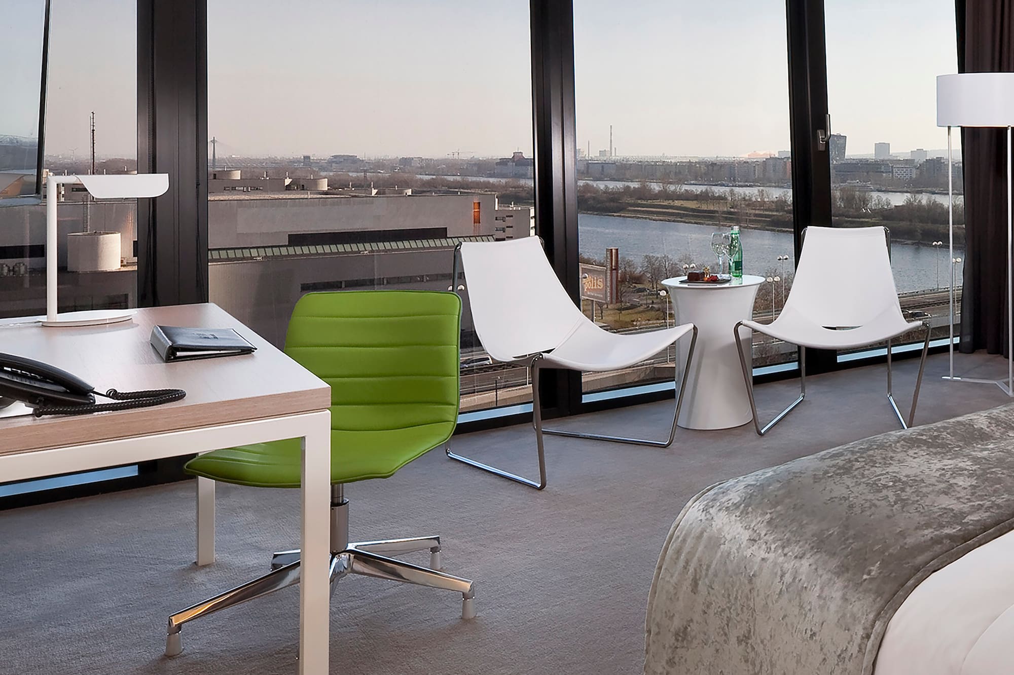 a room with a bed and chairs and a table