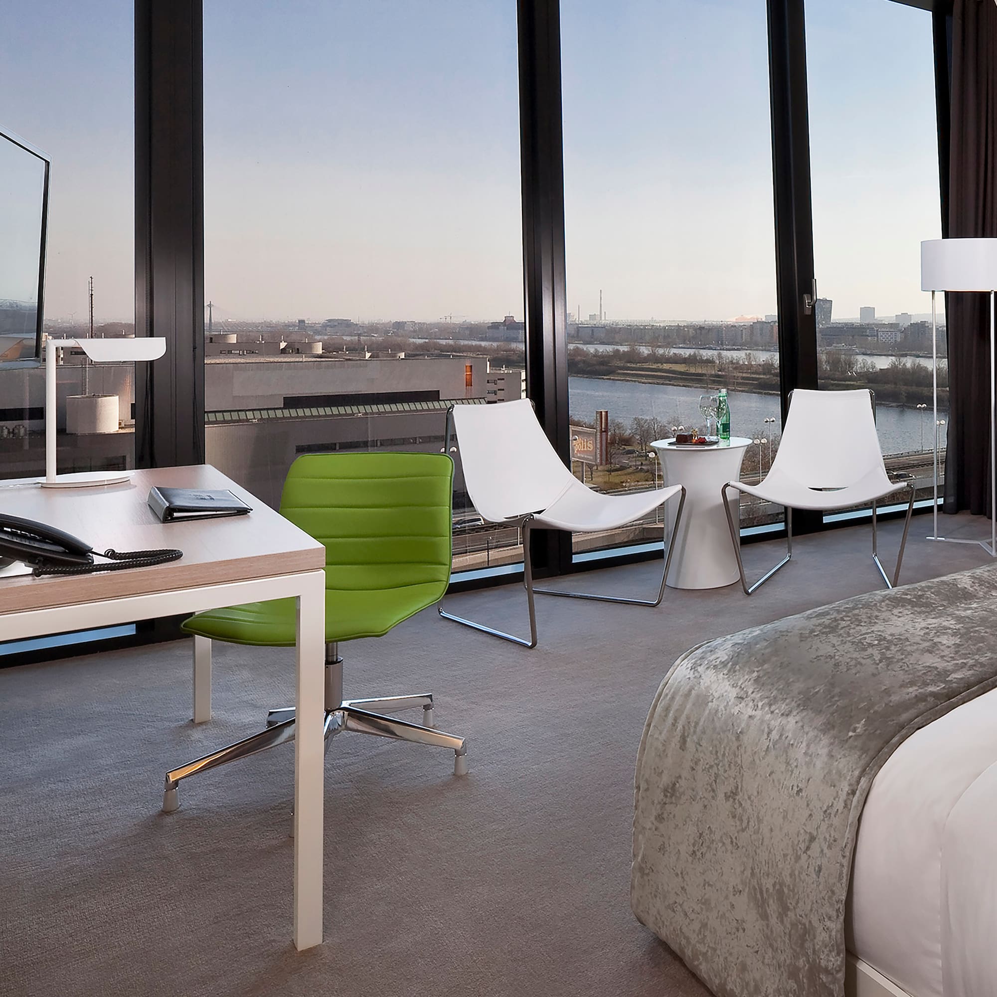 a room with a bed and chairs and a table