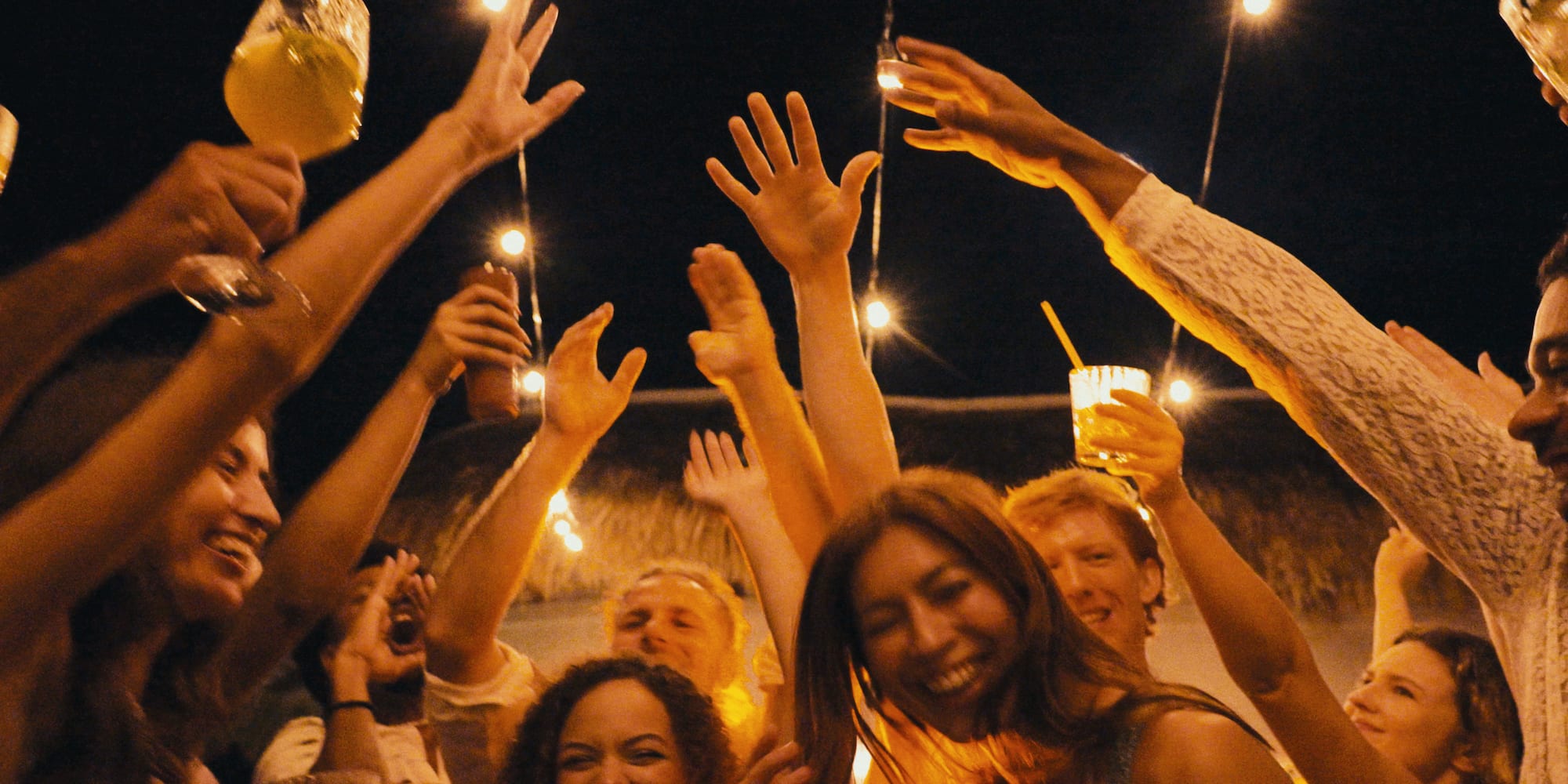 a group of people holding up their hands