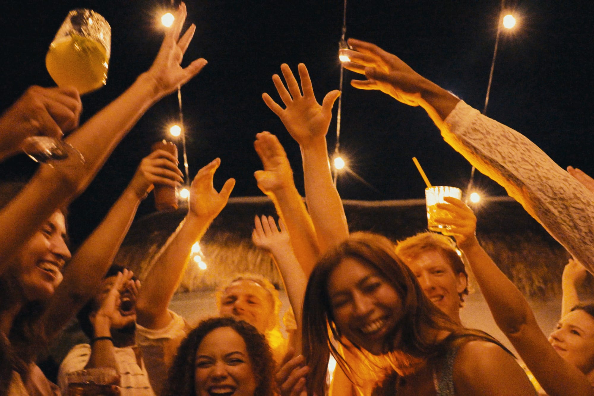 a group of people holding up their hands