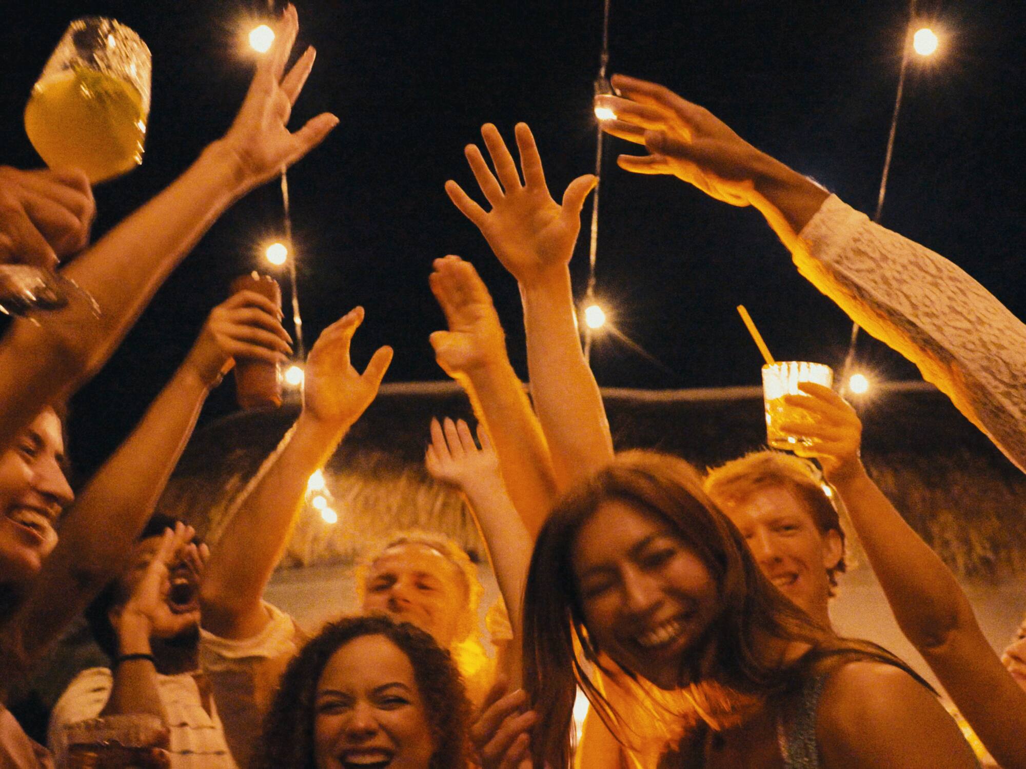 a group of people holding up their hands