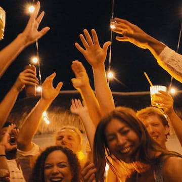 a group of people holding up their hands