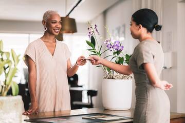 a woman handing a card to a woman