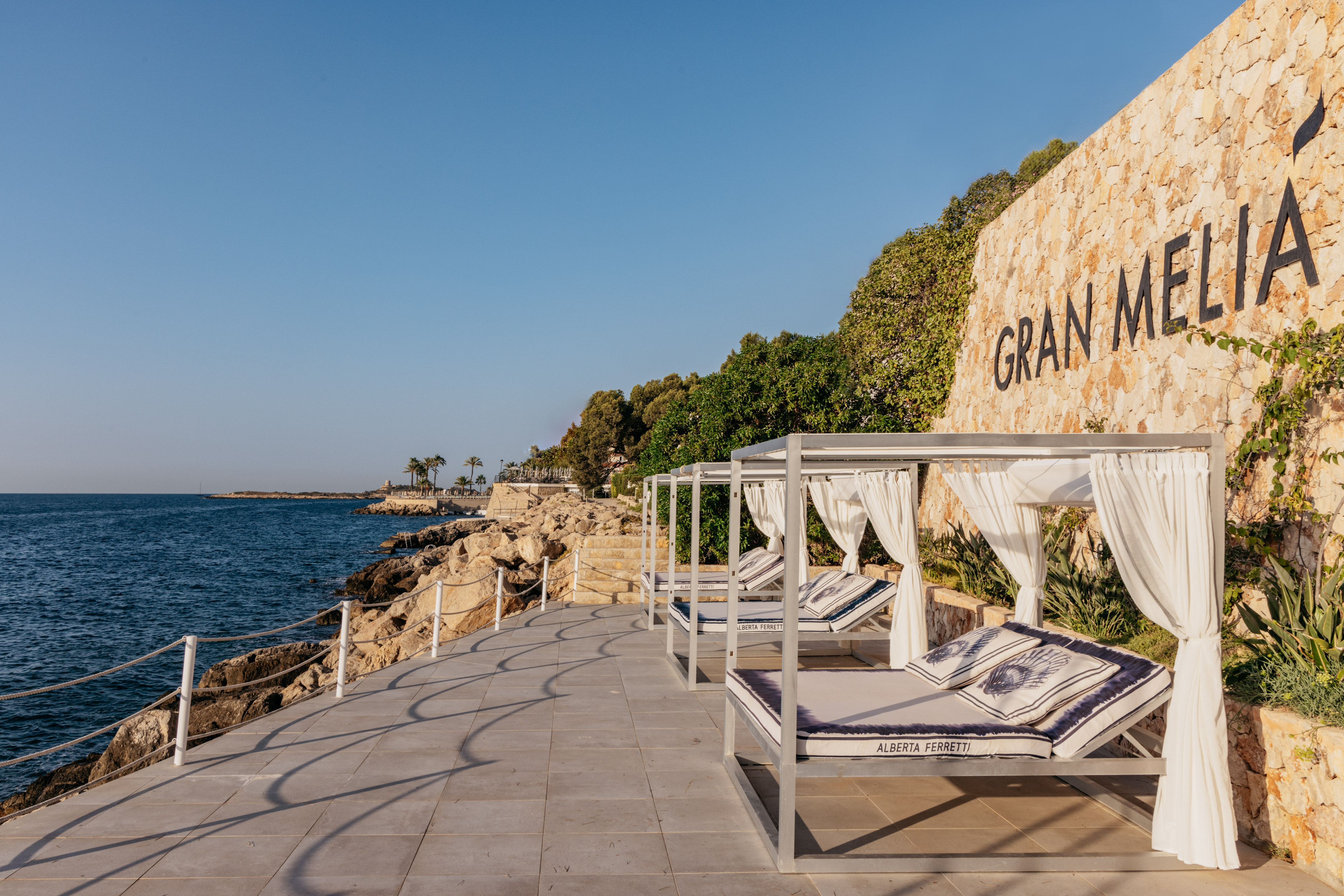 Gran Melia oceanfront resort featuring luxury cabanas and rocky shoreline.