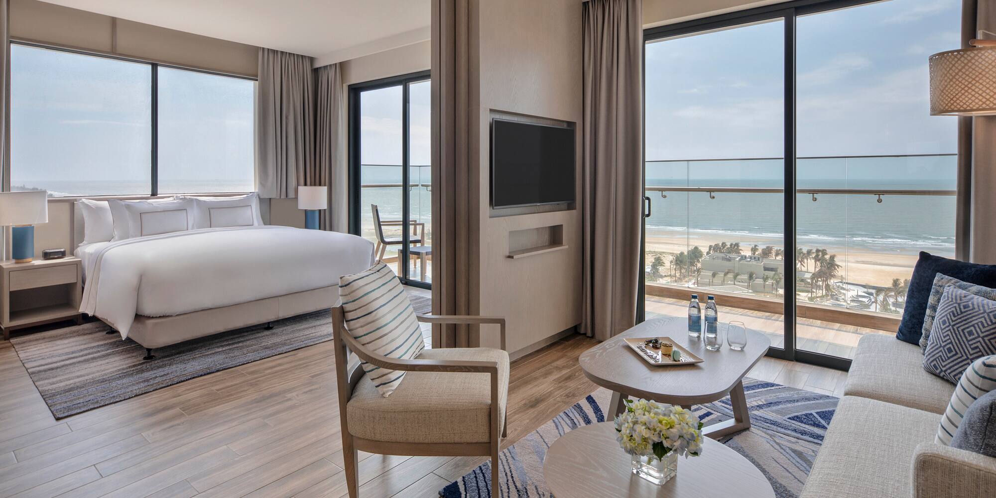 a room with a bed and a television