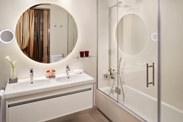 a bathroom with a mirror and a shower