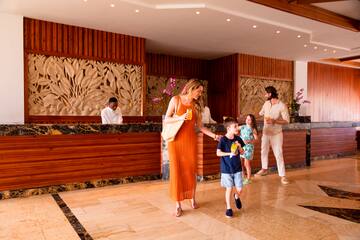 a woman and a boy walking in a lobby