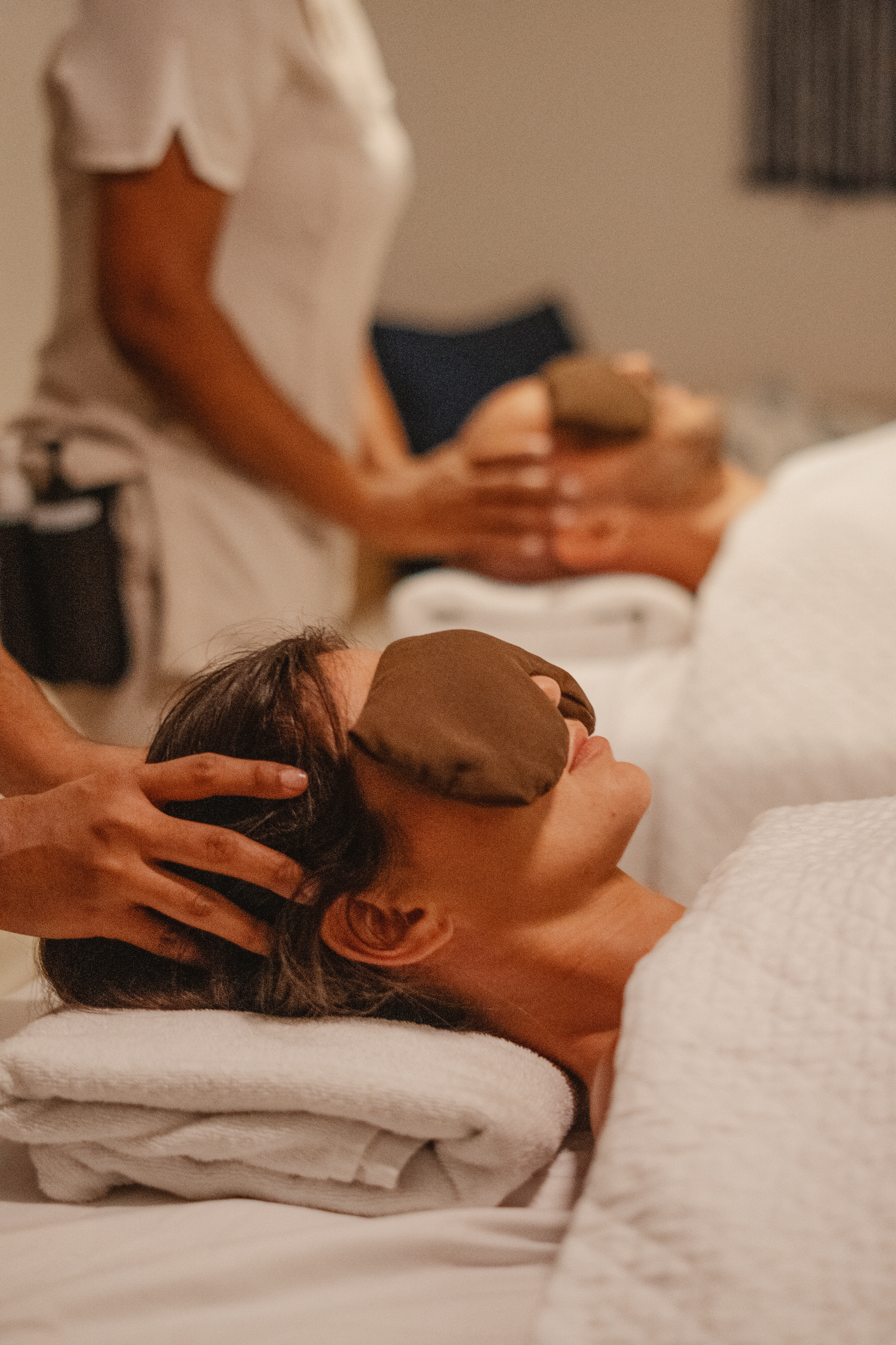 a woman lying down with a mask on her face