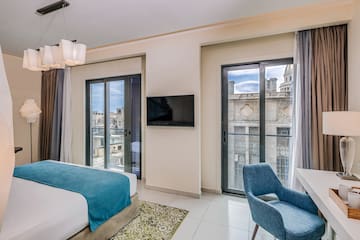 a bedroom with a tv and a bed