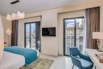 a bedroom with a tv and a bed