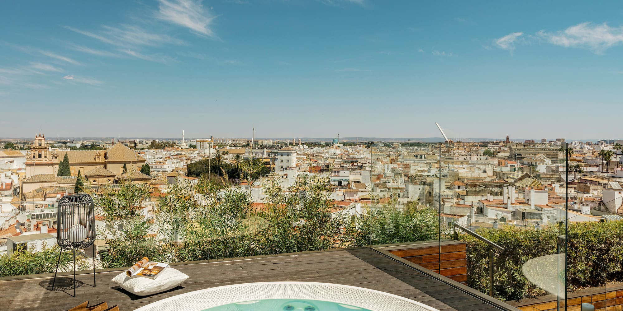 a hot tub on a rooftop overlooking a city
