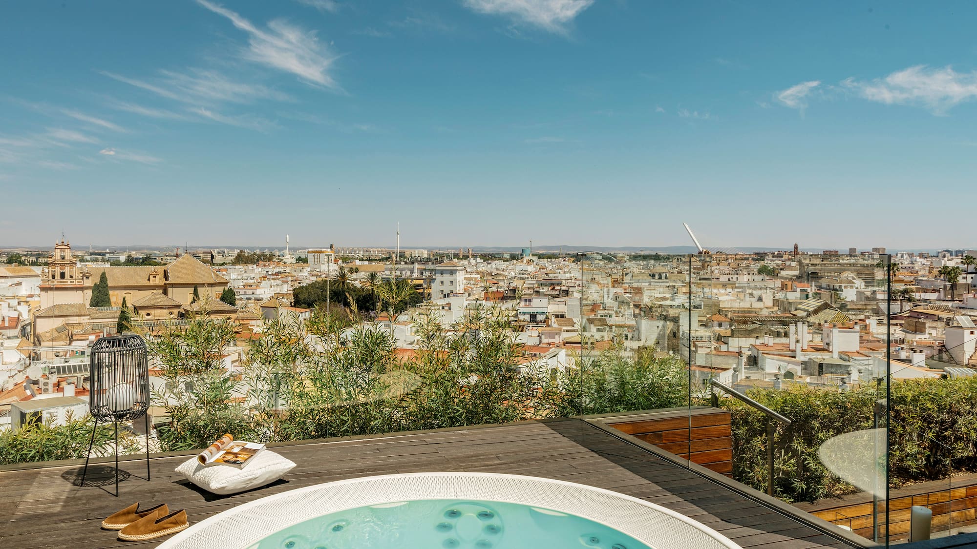 a hot tub on a rooftop overlooking a city