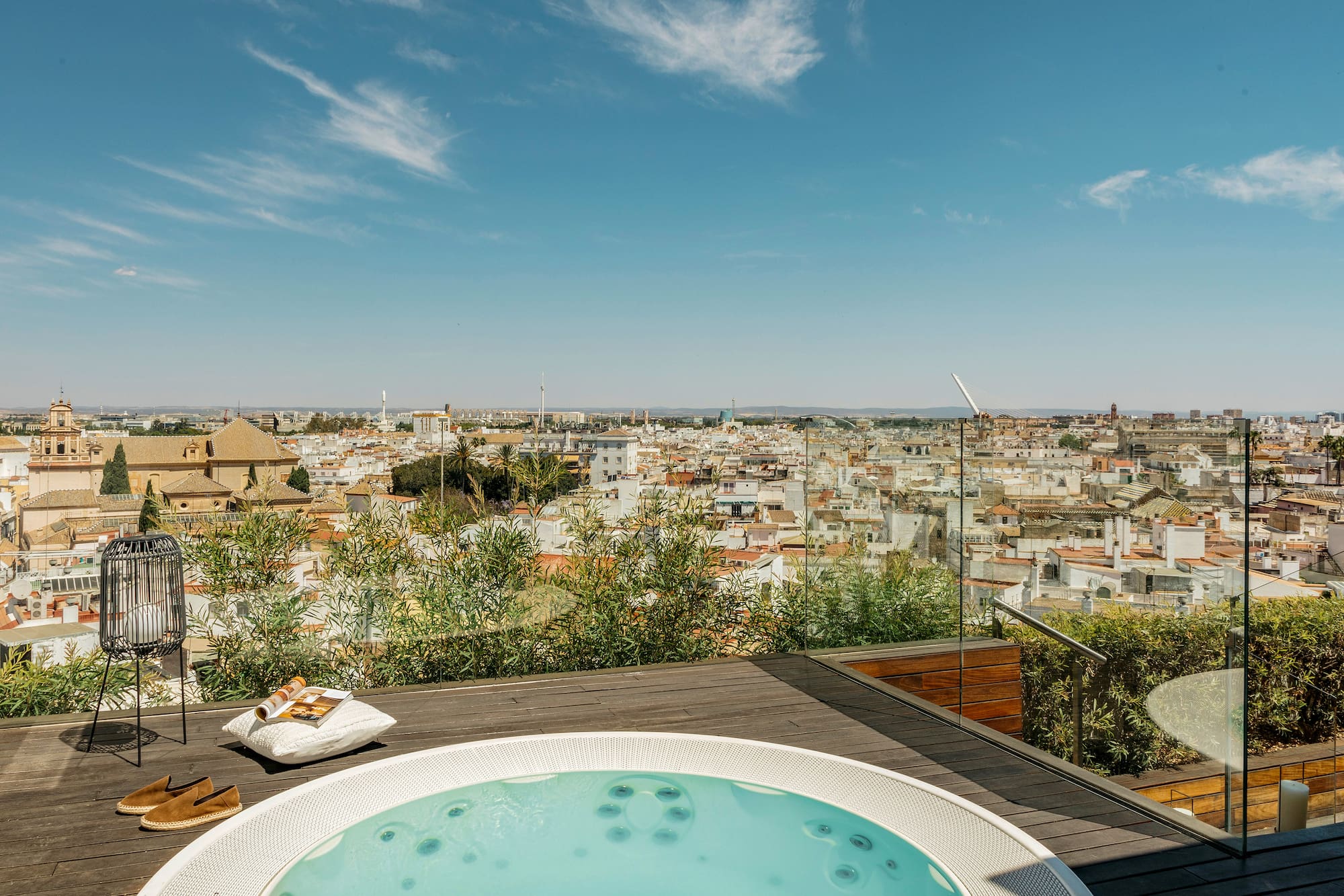 a hot tub on a rooftop overlooking a city