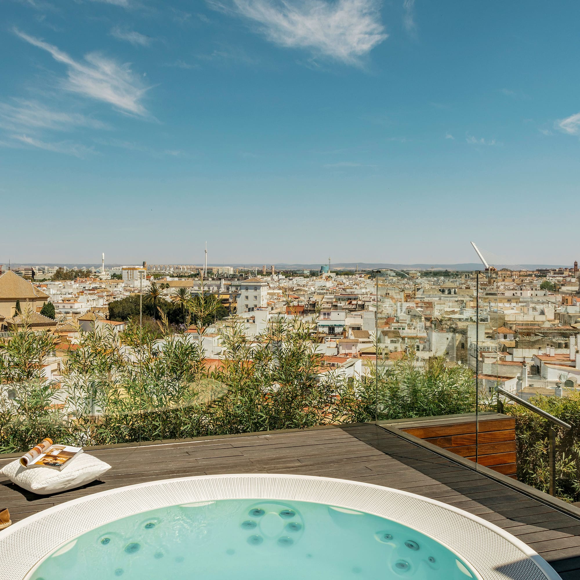 a hot tub on a rooftop overlooking a city