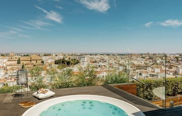 a hot tub on a rooftop overlooking a city