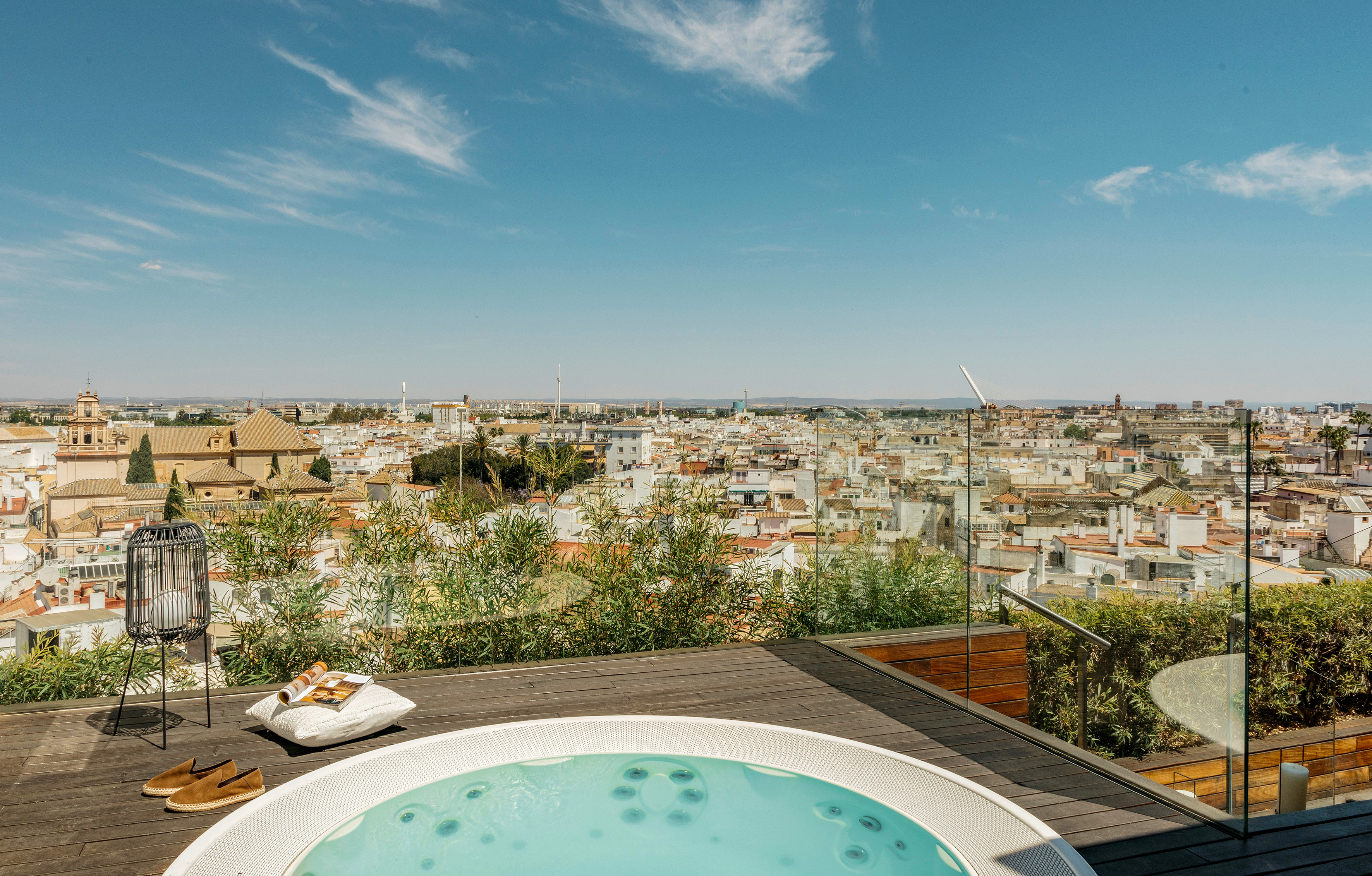a hot tub on a rooftop overlooking a city