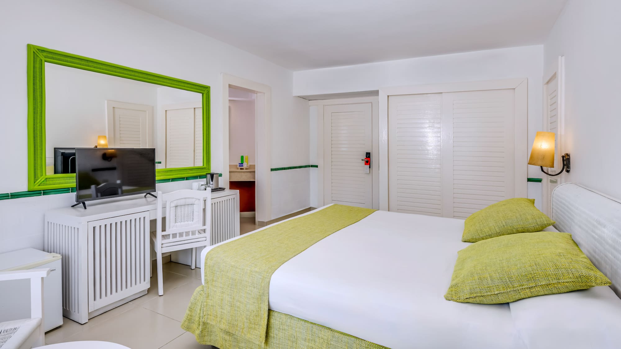 a room with a bed and a television