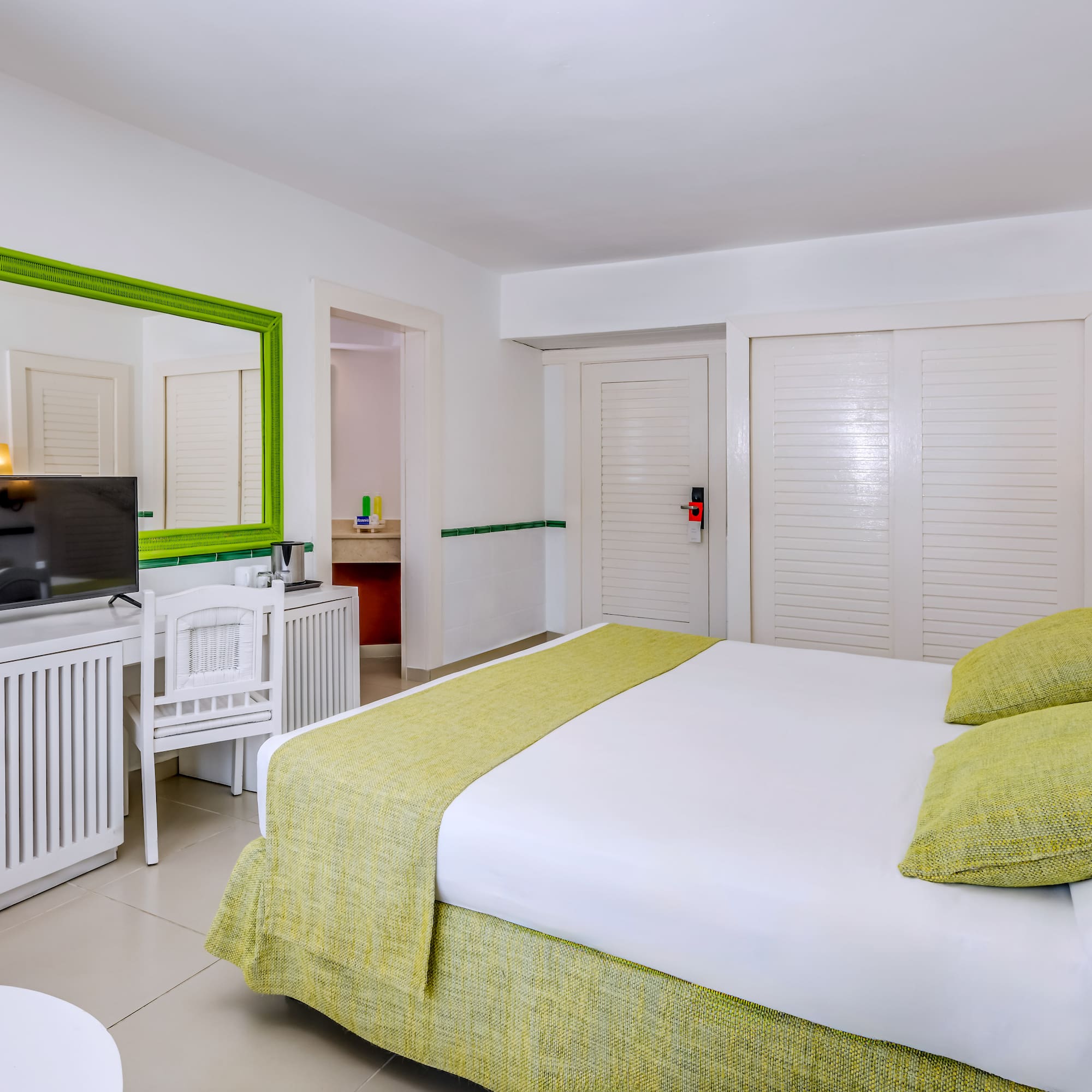 a room with a bed and a television