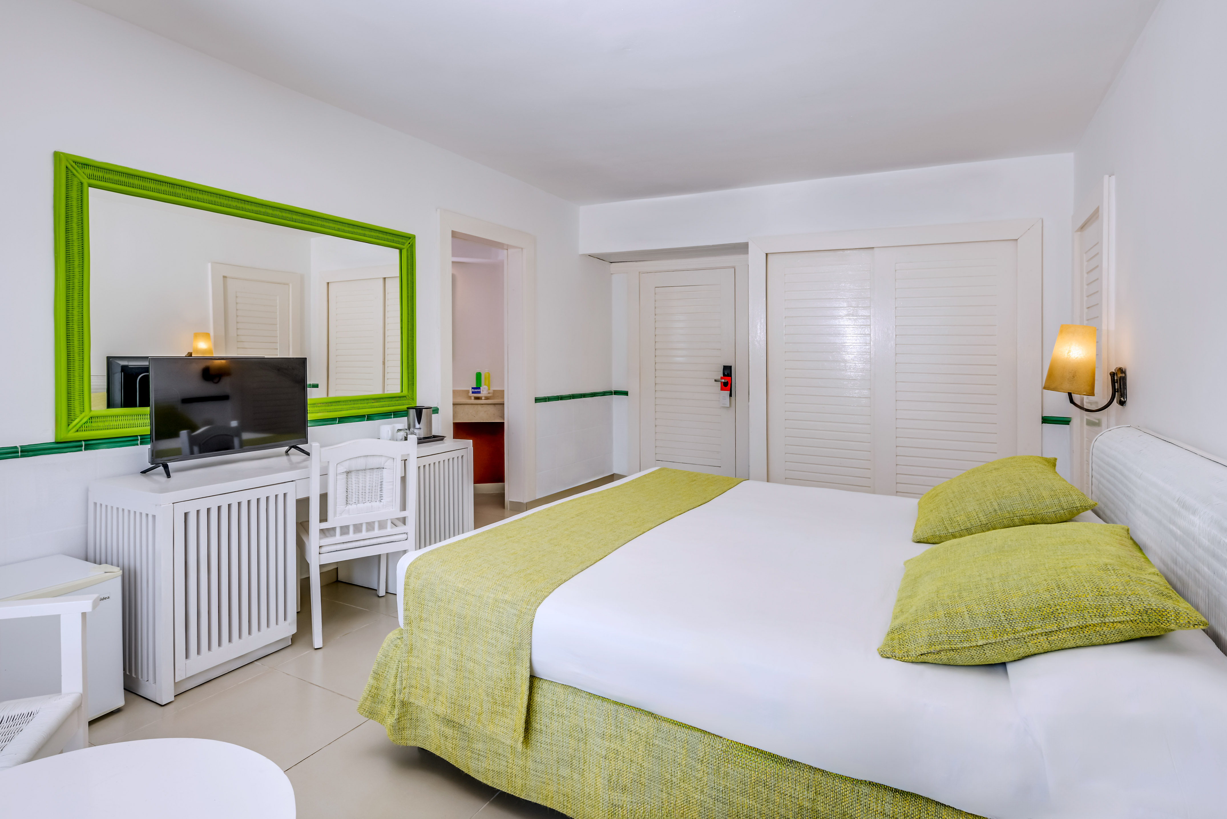 a room with a bed and a television