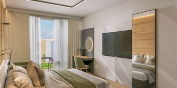 a room with a bed and a television