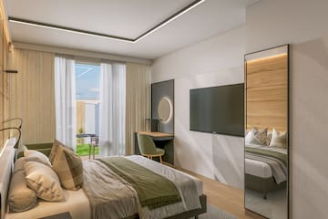 a room with a bed and a television