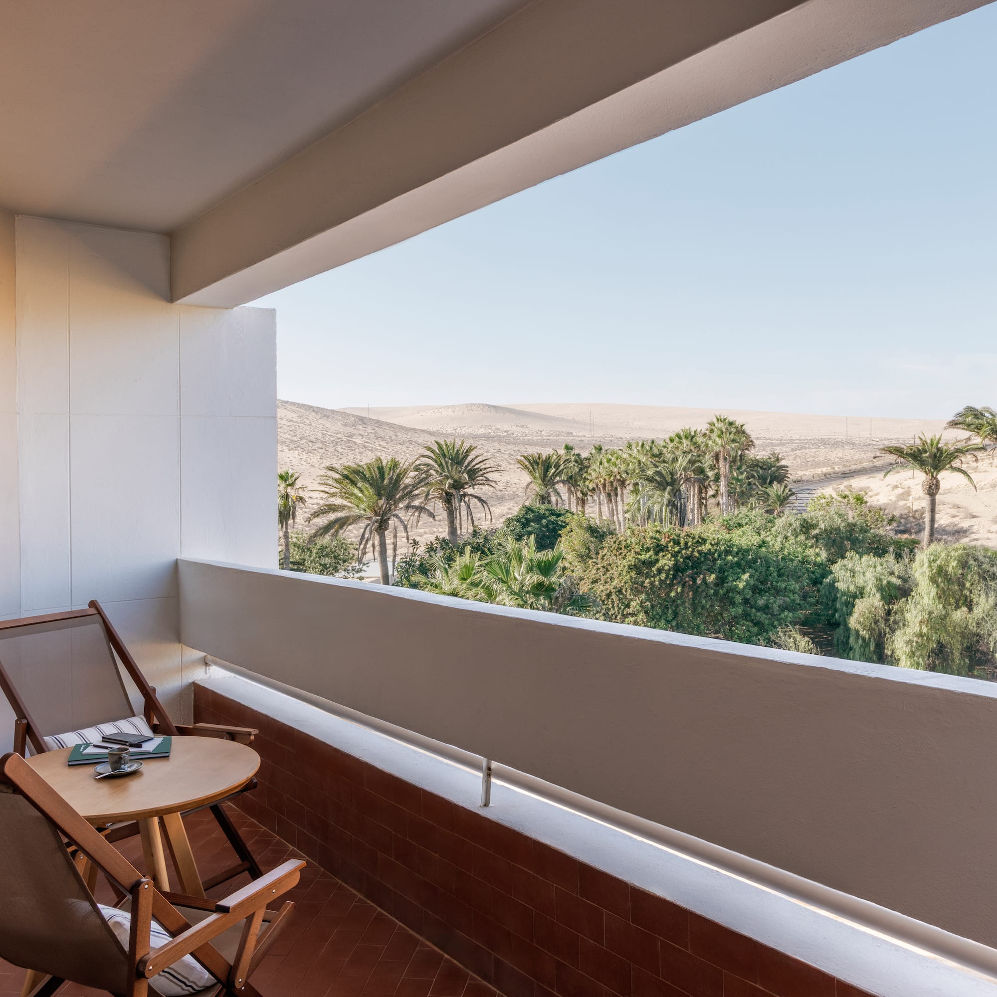 a balcony with a table and chairs