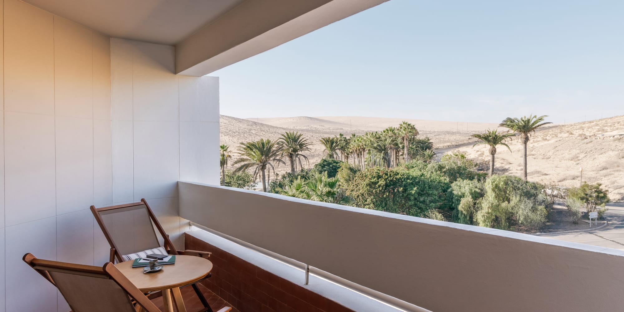 a balcony with a table and chairs