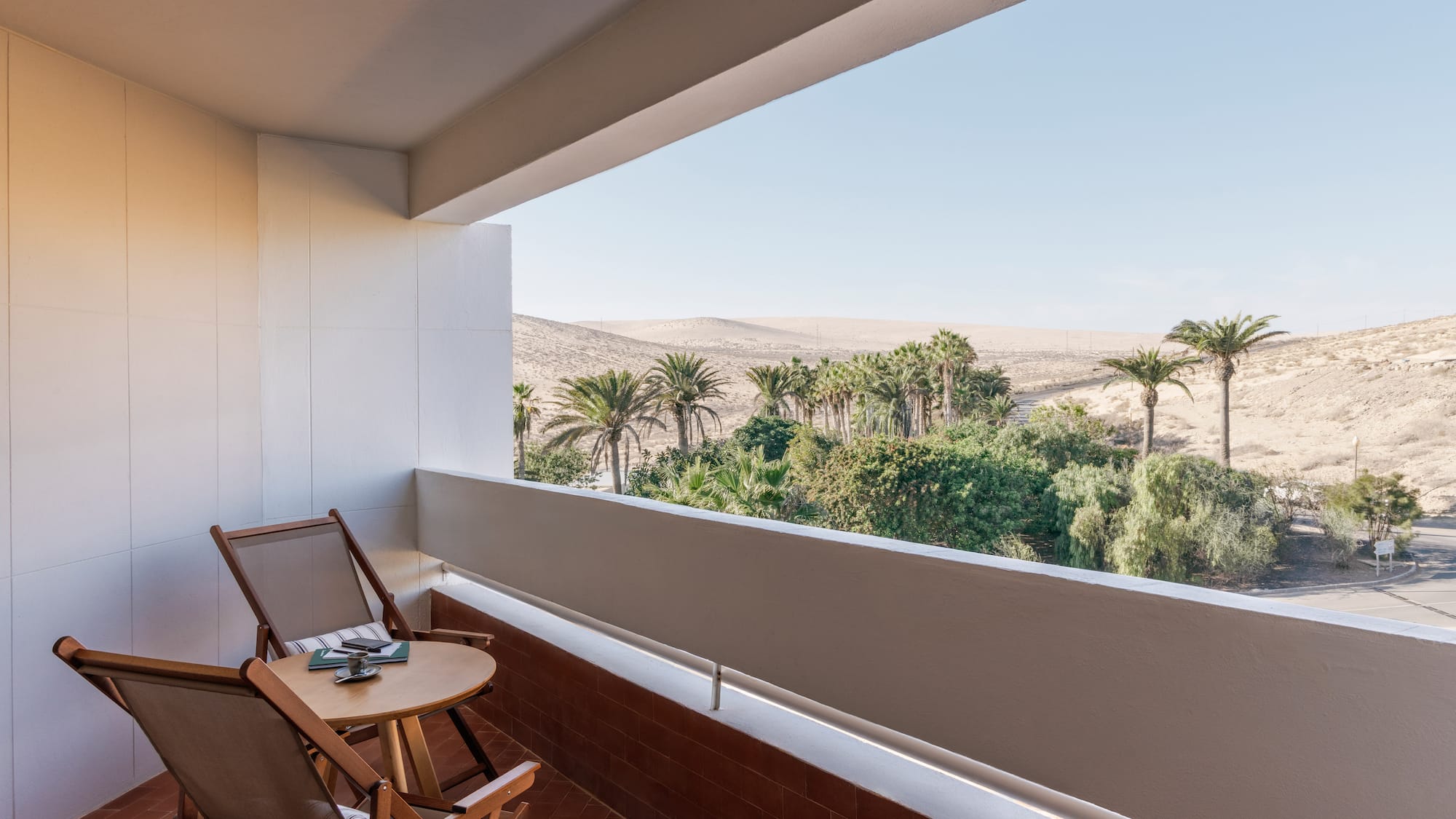 a balcony with a table and chairs