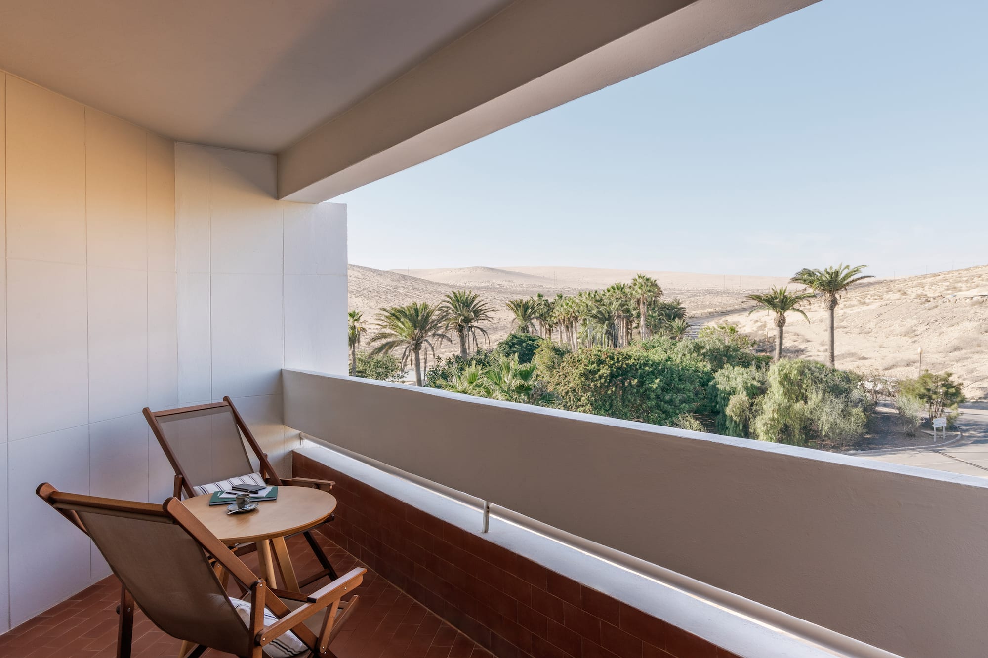 a balcony with a table and chairs
