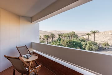 a balcony with a table and chairs