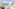 Luxury hotel balcony with outdoor hot tub and panoramic ocean view.