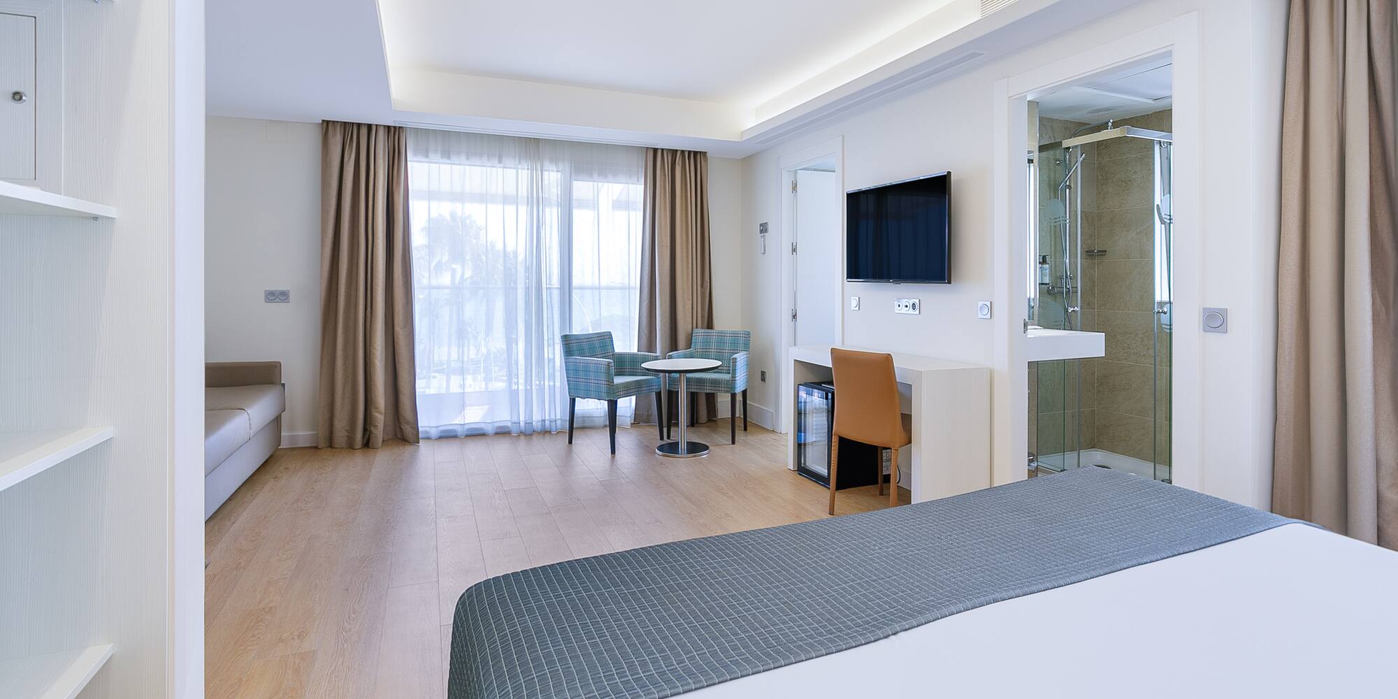 a room with a bed and a tv