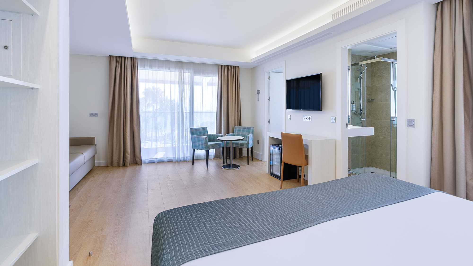 a room with a bed and a tv