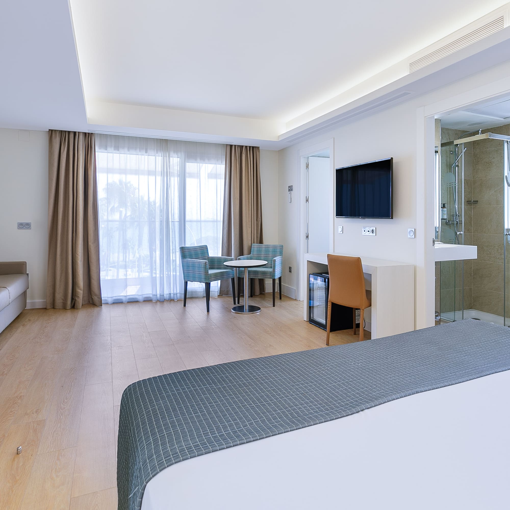 a room with a bed and a tv