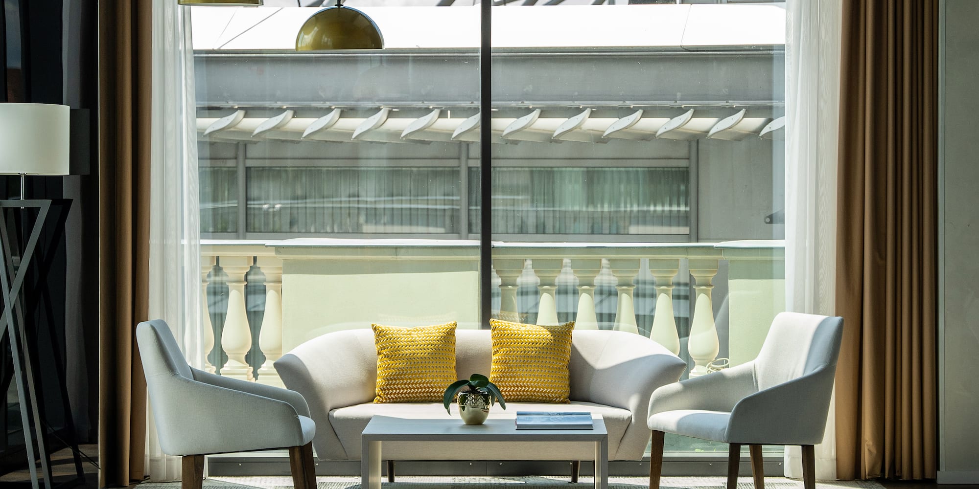 a room with a couch and chairs