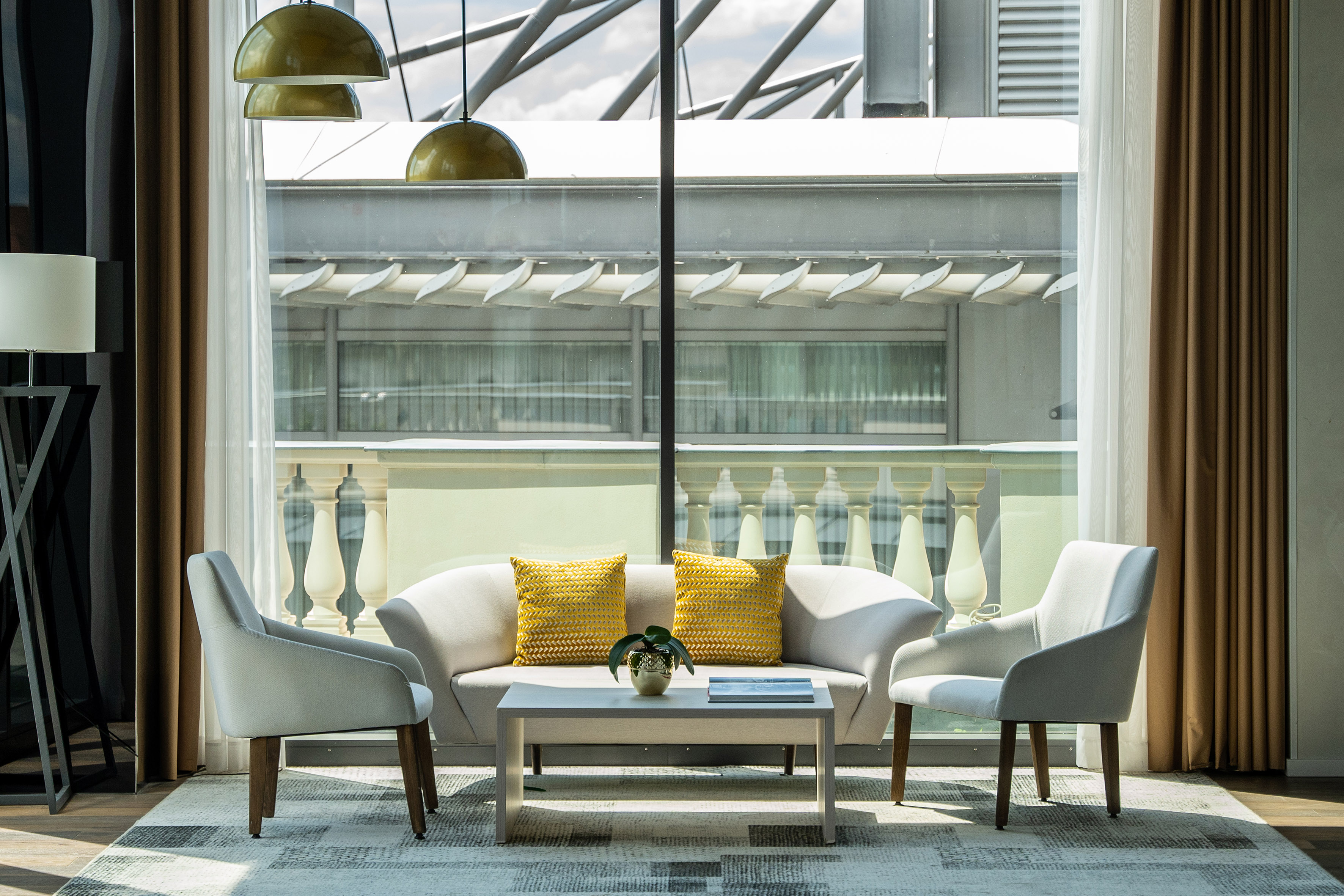 a room with a couch and chairs