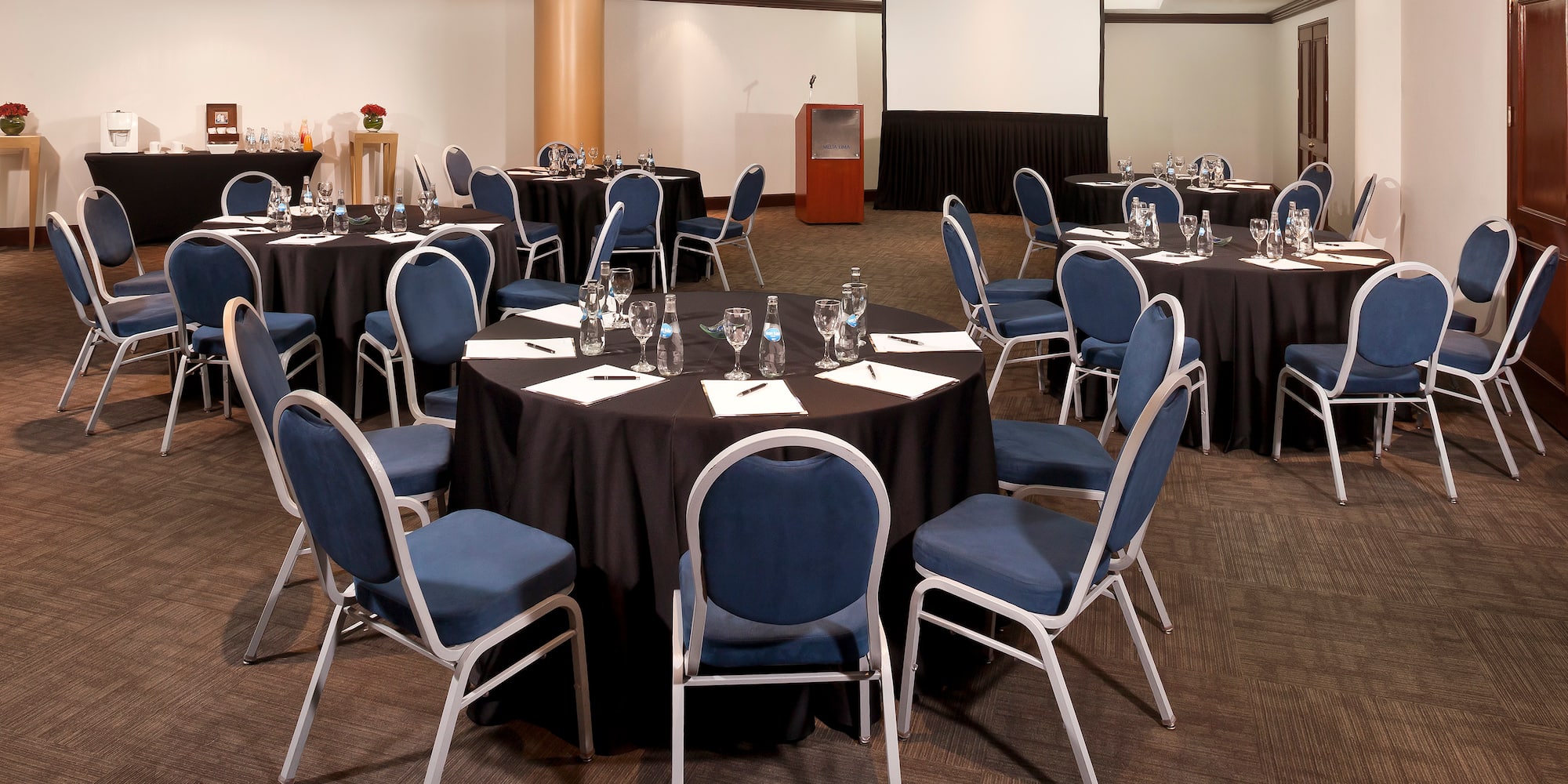 a room with round tables and chairs