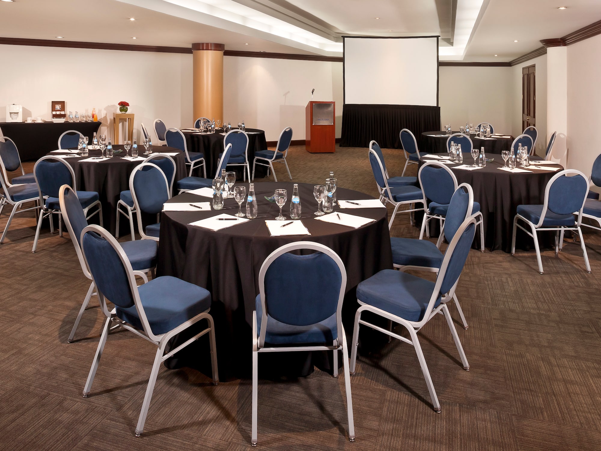 a room with round tables and chairs