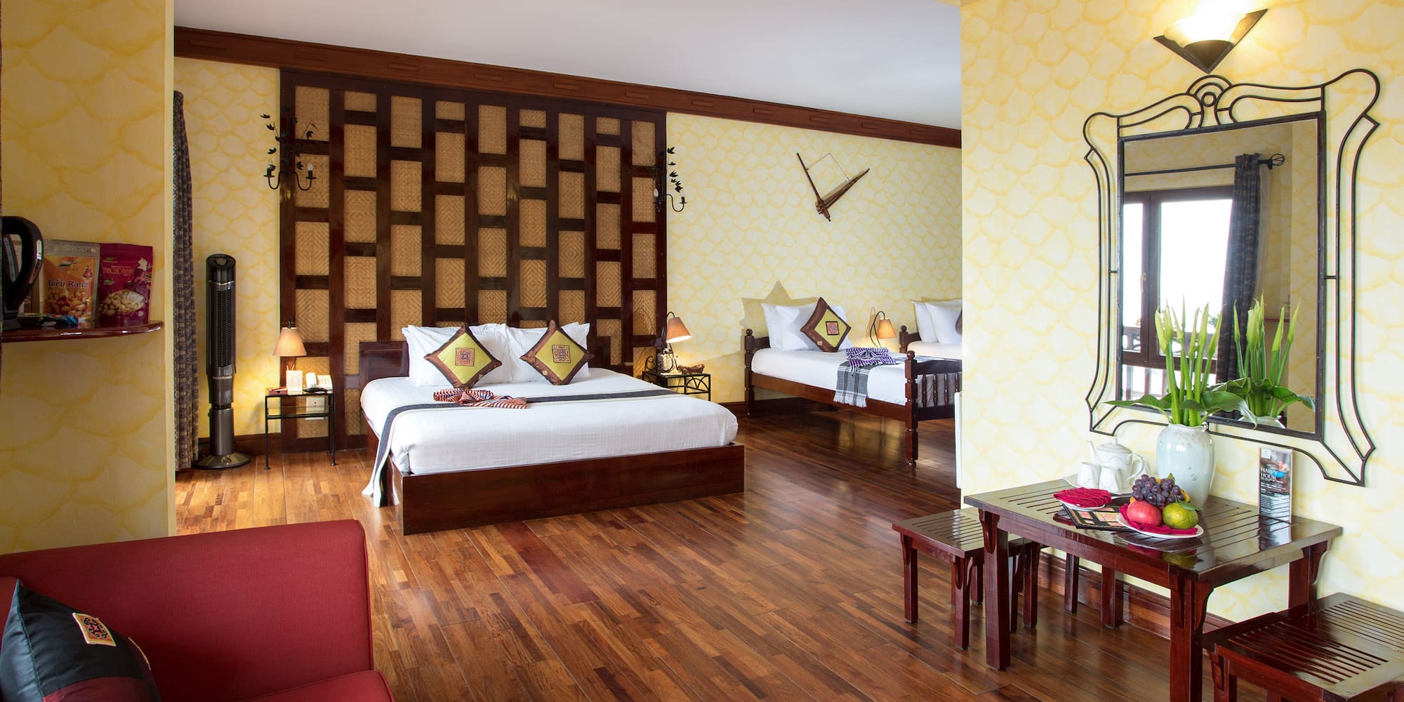 a room with two beds and a mirror