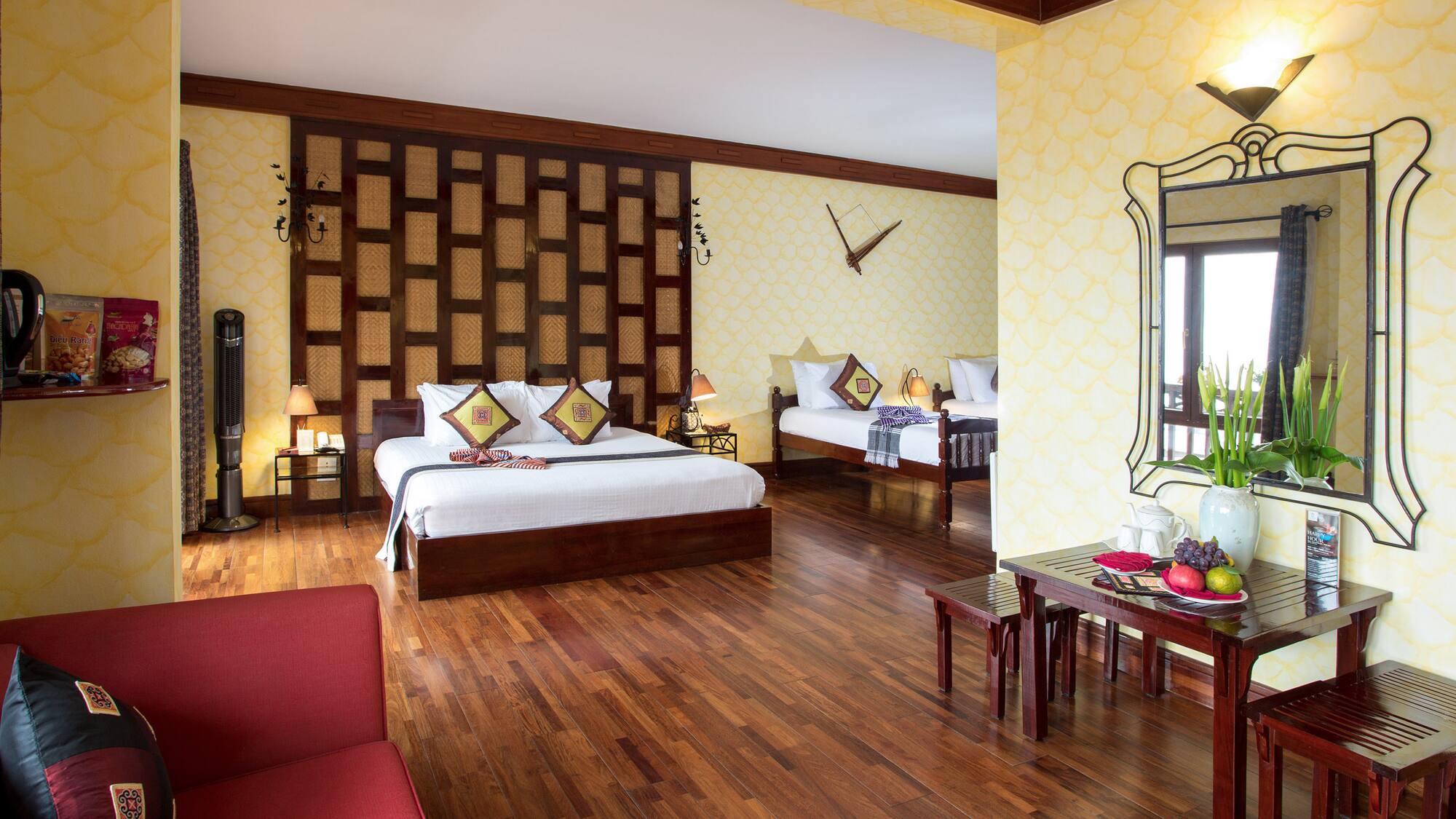 a room with two beds and a mirror
