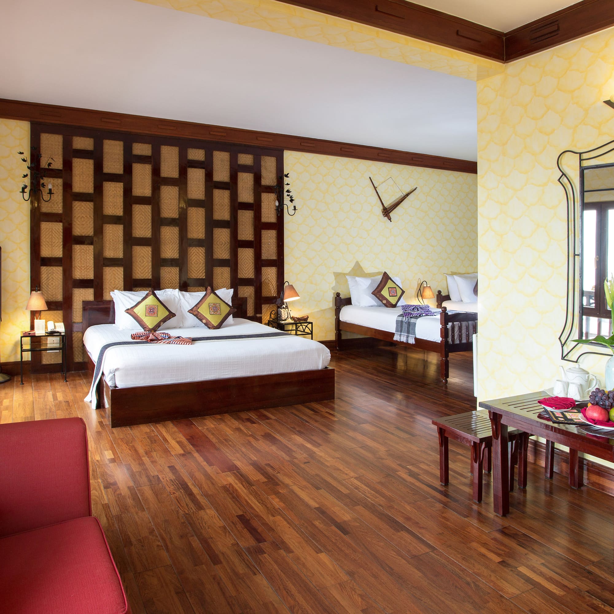 a room with two beds and a mirror