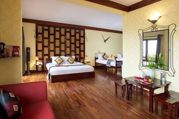 a room with two beds and a mirror