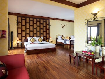 a room with two beds and a mirror