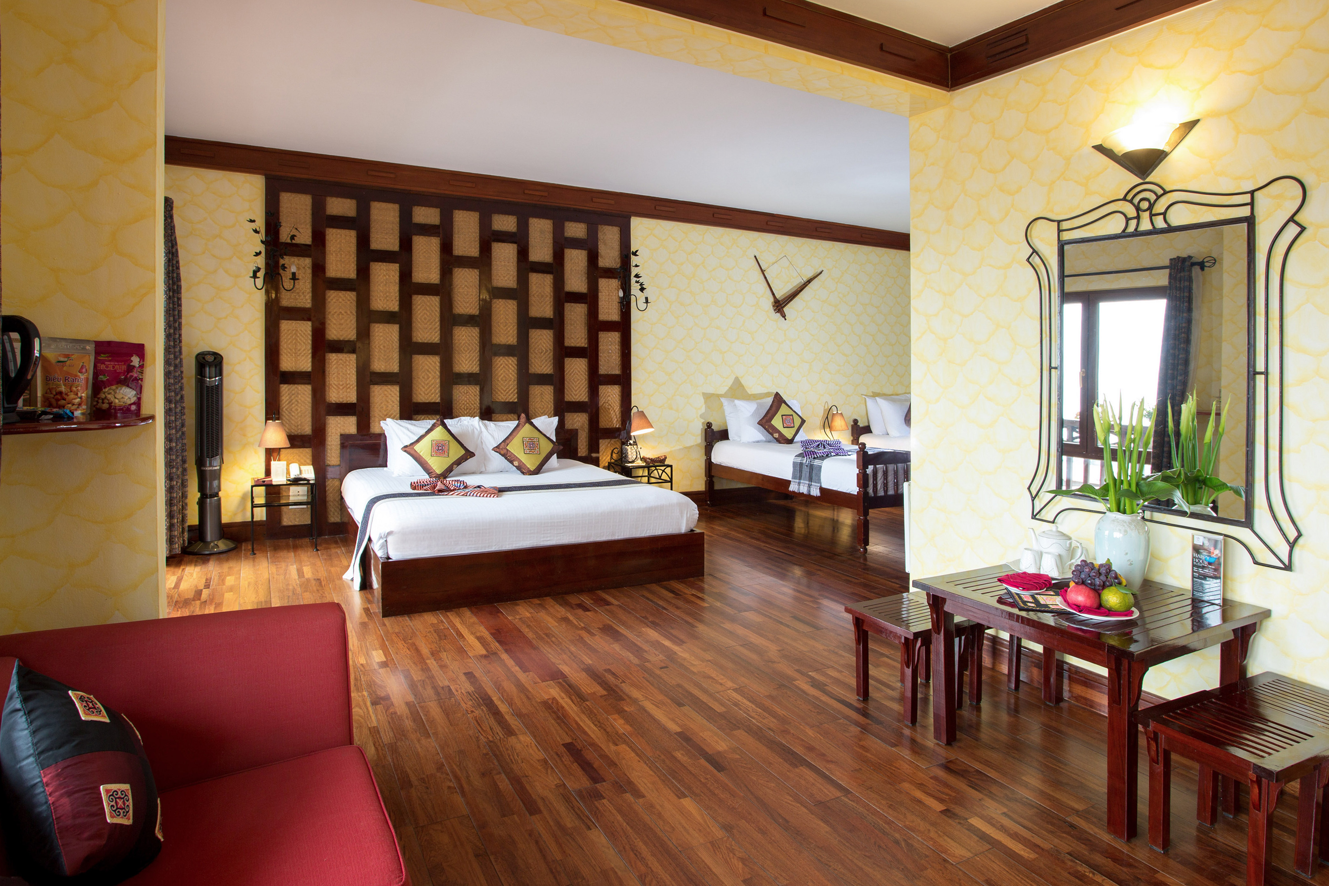 a room with two beds and a mirror