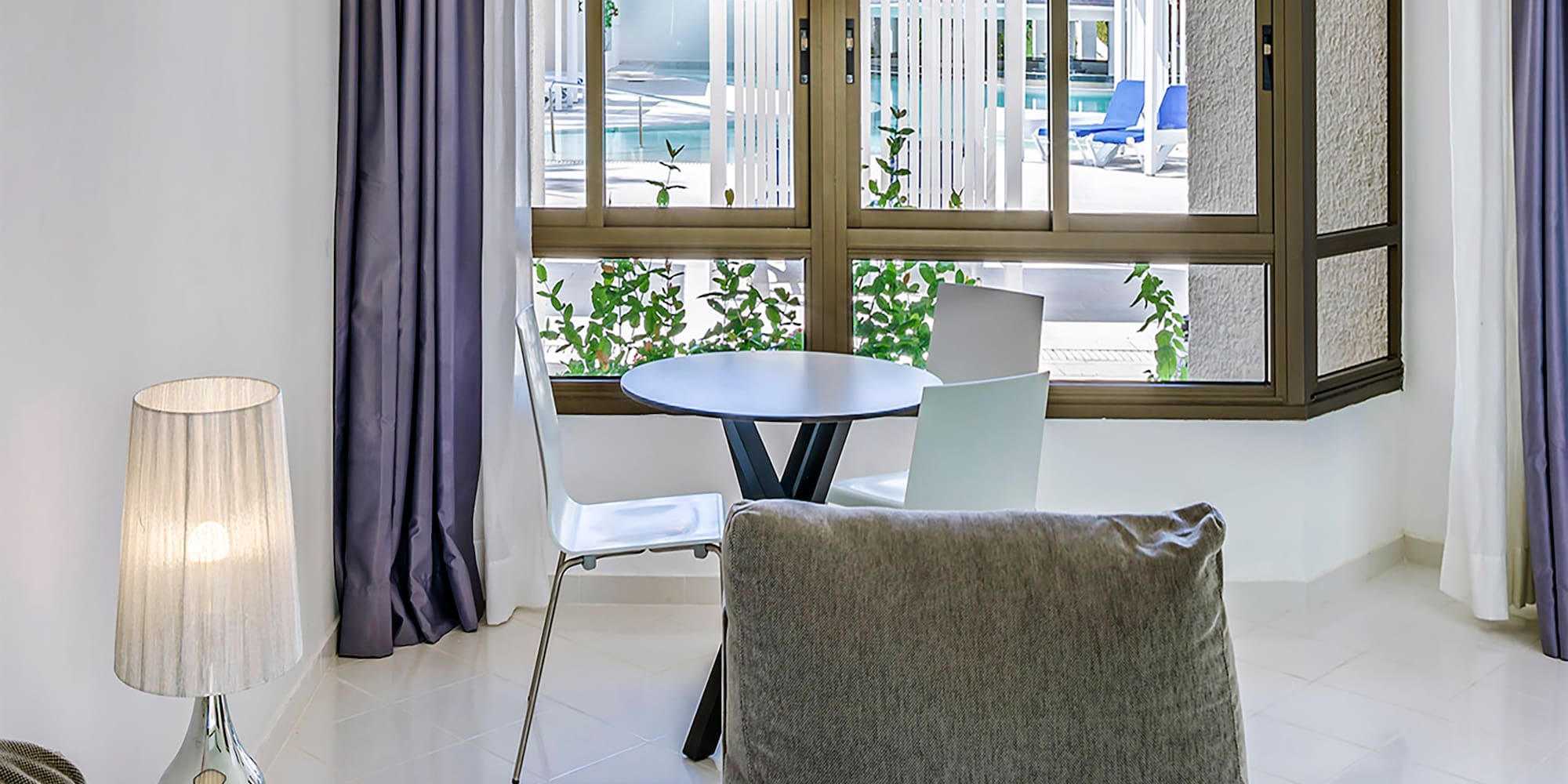 a living room with a table and chairs