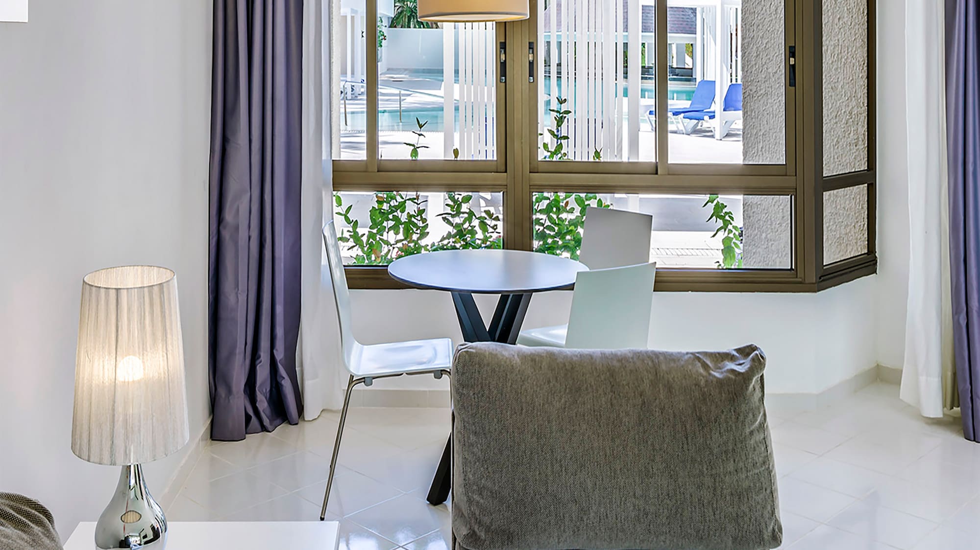 a living room with a table and chairs