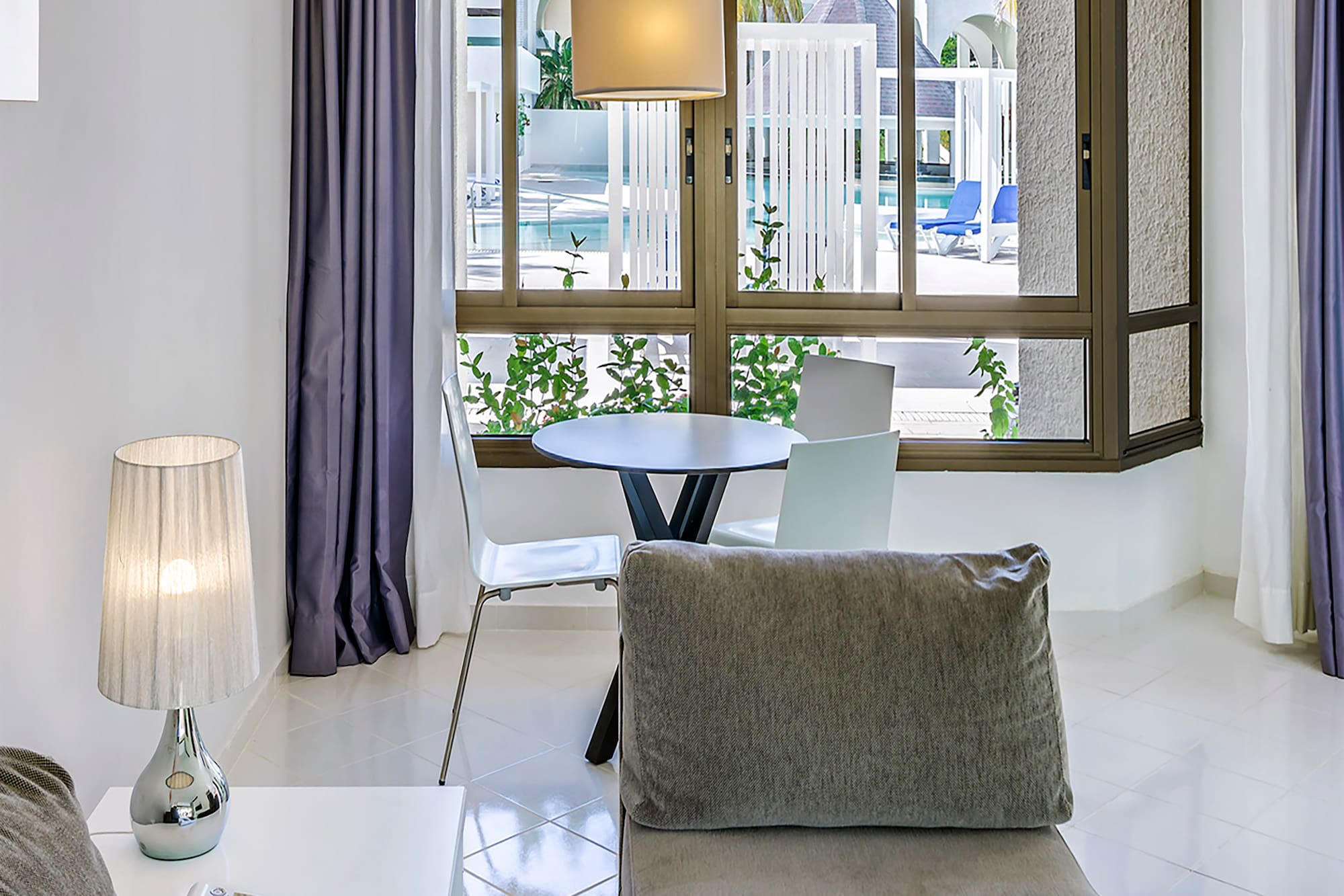 a living room with a table and chairs